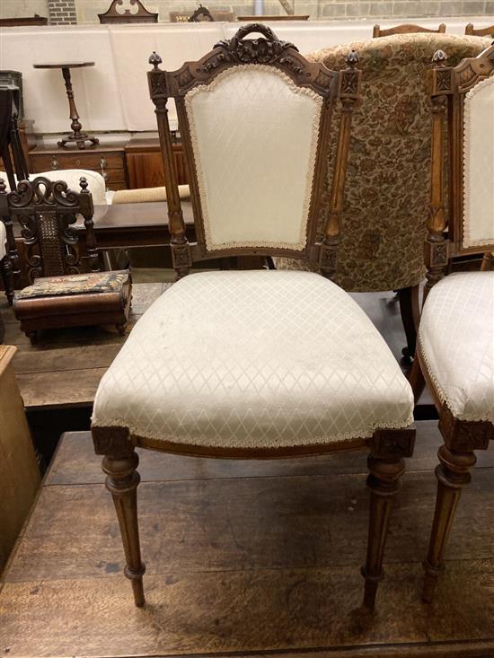 A pair of Victorian carved walnut salon chairs